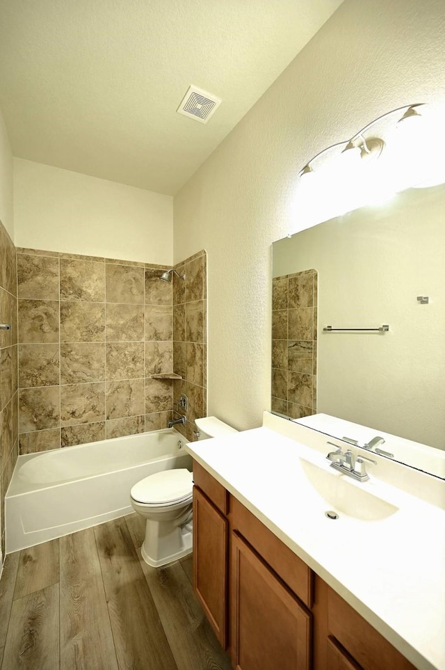 9002 Lacombe Ln, Tomball, TX 77375 - full bathroom with wood finished floors, vanity, a textured wall, and shower / washtub combination