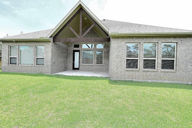 9002 Lacombe Ln, Tomball, TX 77375 - back of property with brick siding, a patio, a yard, and a shingled roof