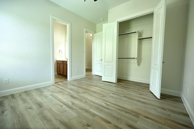 9002 Lacombe Ln, Tomball, TX 77375 - unfurnished bedroom with light wood-style floors, a closet, and ensuite bath