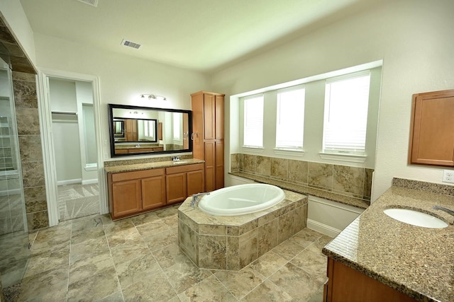 9002 Lacombe Ln, Tomball, TX 77375 - full bath featuring two vanities, a garden tub, and a walk in closet