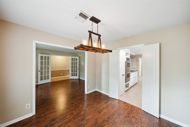 4117 Tilson Ln, Houston, TX 77080 - empty room with wood finished floors, a chandelier, and french doors