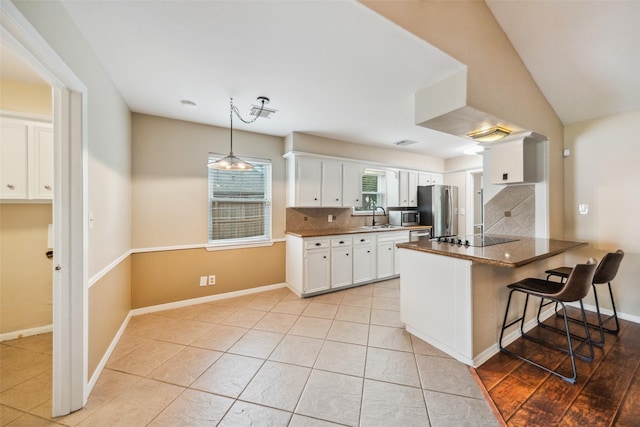 4117 Tilson Ln, Houston, TX 77080 - kitchen featuring white cabinets, a peninsula, decorative backsplash, and appliances with stainless steel finishes