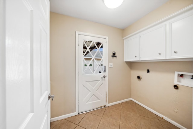 4117 Tilson Ln, Houston, TX 77080 - laundry area featuring cabinet space, hookup for an electric dryer, light tile patterned floors, and hookup for a washing machine