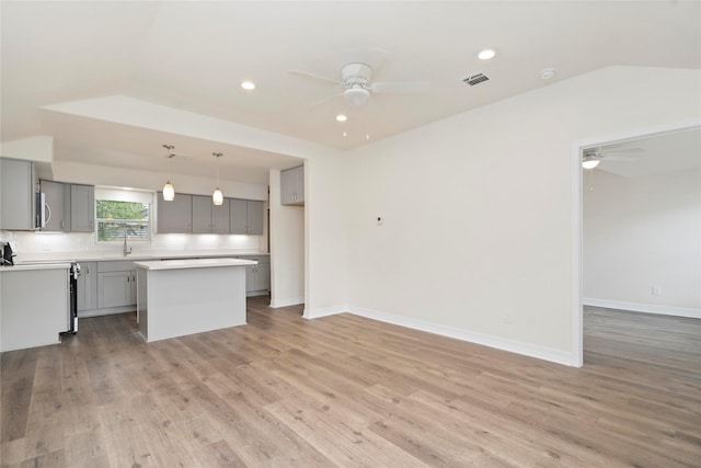 798 Fair St, Houston, TX 77088 - kitchen with a ceiling fan, gray cabinetry, a center island, light countertops, and recessed lighting