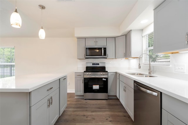 798 Fair St, Houston, TX 77088 - kitchen with stainless steel appliances, gray cabinetry, dark wood finished floors, and light countertops