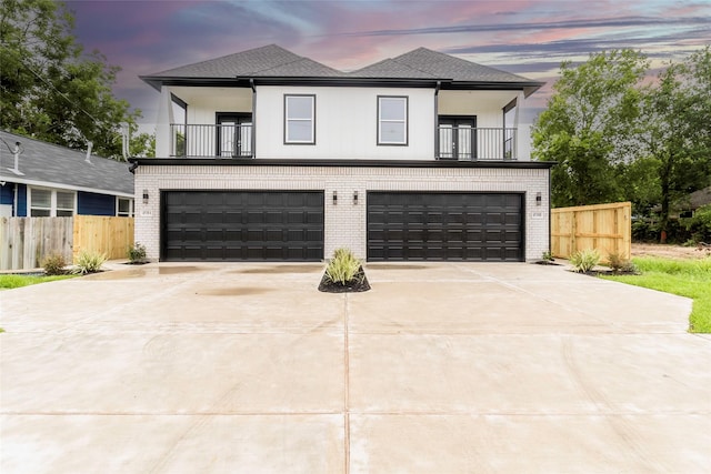 4538 White Rock St, Houston, TX 77051 - contemporary home featuring a balcony, an attached garage, concrete driveway, and brick siding