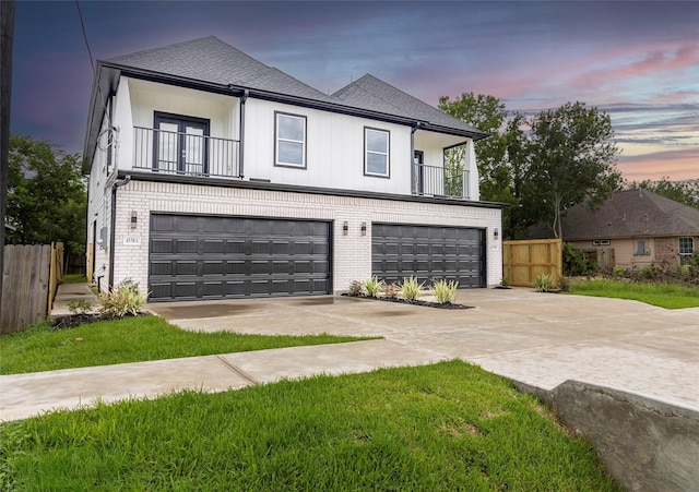 4538 White Rock St, Houston, TX 77051 - view of front facade with a balcony, driveway, brick siding, and an attached garage