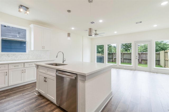 4538 White Rock St, Houston, TX 77051 - kitchen with stainless steel dishwasher, dark wood-style floors, light countertops, hanging light fixtures, and tasteful backsplash