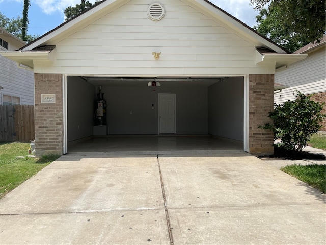 2827 Cypress Island Dr, Houston, TX 77073 - garage with driveway and water heater
