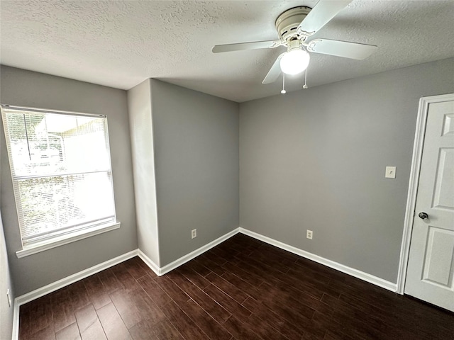 2827 Cypress Island Dr, Houston, TX 77073 - spare room featuring a textured ceiling, ceiling fan, and dark wood-style flooring
