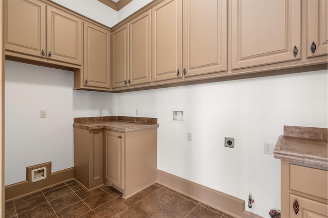 3045 S Island Dr, Seabrook, TX 77586 - washroom with hookup for an electric dryer, hookup for a washing machine, cabinet space, gas dryer hookup, and dark tile patterned flooring