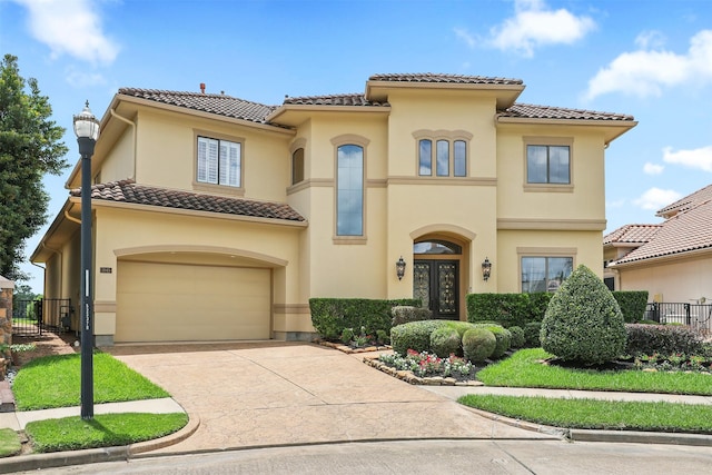 3045 S Island Dr, Seabrook, TX 77586 - mediterranean / spanish-style home featuring a tile roof, an attached garage, stucco siding, and concrete driveway