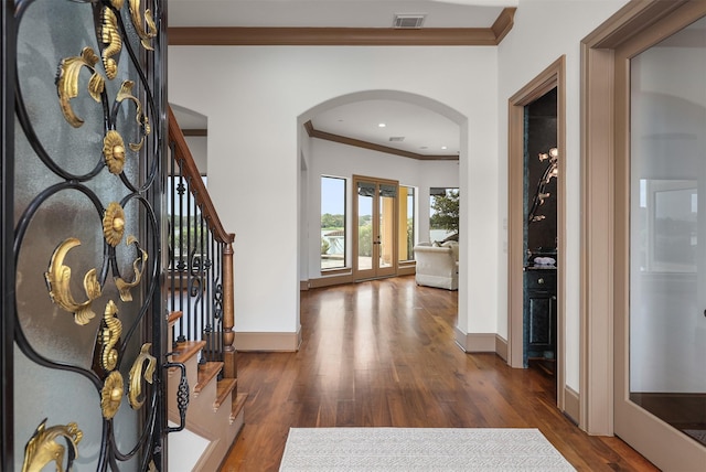 3045 S Island Dr, Seabrook, TX 77586 - foyer featuring arched walkways, ornamental molding, french doors, wood finished floors, and stairway