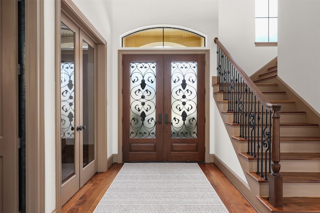 3045 S Island Dr, Seabrook, TX 77586 - entrance foyer with french doors, light wood-style flooring, and stairs