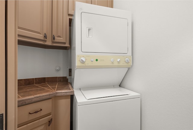 3045 S Island Dr, Seabrook, TX 77586 - laundry area with stacked washer / dryer and cabinet space