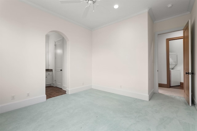 3045 S Island Dr, Seabrook, TX 77586 - spare room with stacked washer / dryer, carpet floors, crown molding, arched walkways, and a ceiling fan