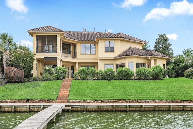 3045 S Island Dr, Seabrook, TX 77586 - back of house with a water view, a tile roof, stucco siding, and a yard
