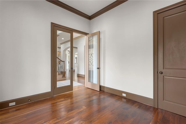 3045 S Island Dr, Seabrook, TX 77586 - empty room featuring ornamental molding, arched walkways, wood finished floors, and french doors