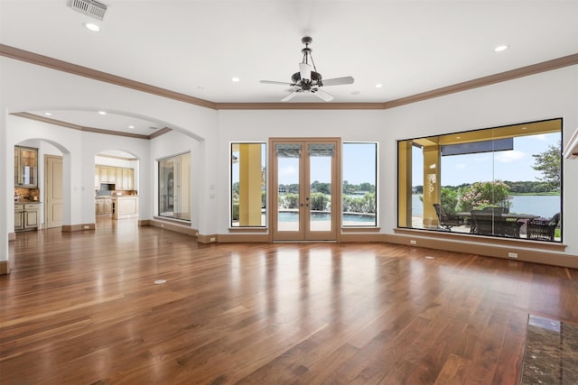 3045 S Island Dr, Seabrook, TX 77586 - unfurnished living room with wood finished floors, ceiling fan, ornamental molding, recessed lighting, and arched walkways