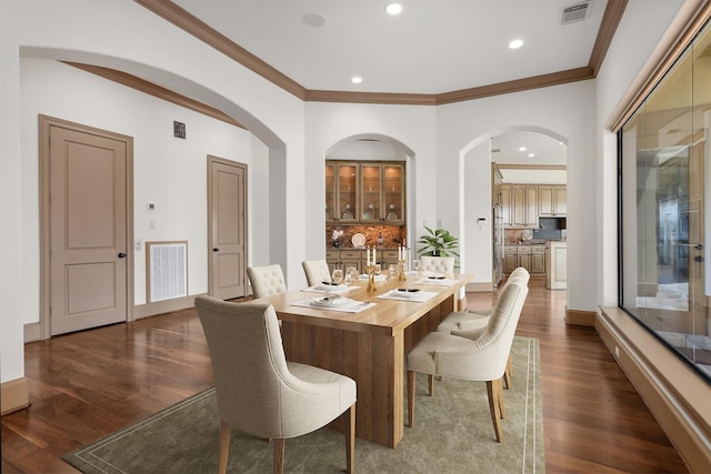 3045 S Island Dr, Seabrook, TX 77586 - dining room featuring arched walkways, dark wood-style floors, crown molding, and recessed lighting