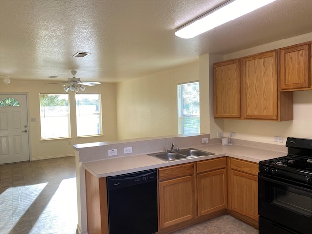 13023 Pleasant Valley Dr, Rosharon, TX 77583 - kitchen featuring black appliances, a peninsula, light countertops, a textured ceiling, and ceiling fan