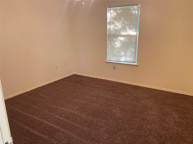 13023 Pleasant Valley Dr, Rosharon, TX 77583 - empty room with dark colored carpet and baseboards