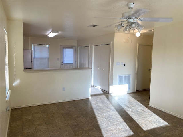 13023 Pleasant Valley Dr, Rosharon, TX 77583 - empty room with a ceiling fan and baseboards