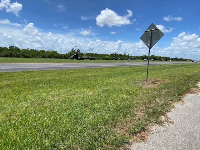 13023 Pleasant Valley Dr, Rosharon, TX 77583 - view of asphalt road with traffic signs