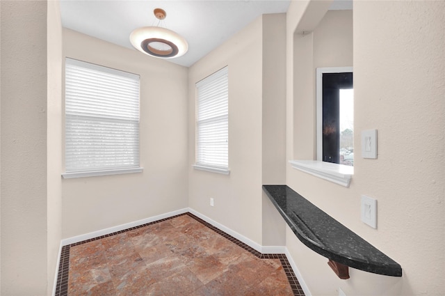 4406 Park Trail Ln, Pasadena, TX 77505 - unfurnished dining area with baseboards and stone finish flooring