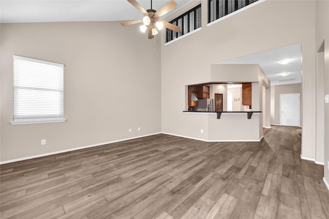 4406 Park Trail Ln, Pasadena, TX 77505 - unfurnished living room featuring wood finished floors, high vaulted ceiling, and a ceiling fan