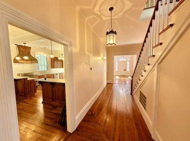 309 E Robert Toombs Ave, Washington, GA 30673 - corridor featuring dark wood-style flooring, stairway, ornamental molding, and a chandelier