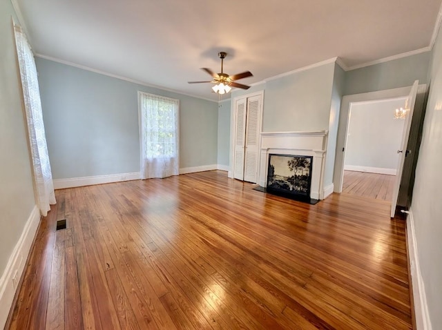 309 E Robert Toombs Ave, Washington, GA 30673 - unfurnished living room with hardwood / wood-style floors, a fireplace with flush hearth, ceiling fan, a chandelier, and ornamental molding