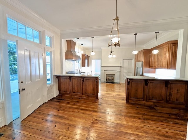 309 E Robert Toombs Ave, Washington, GA 30673 - kitchen featuring freestanding refrigerator, premium range hood, a peninsula, dark wood-style floors, and a decorative wall