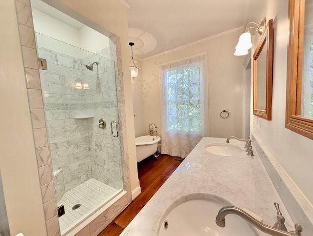 309 E Robert Toombs Ave, Washington, GA 30673 - bathroom featuring wood finished floors, ornamental molding, a shower stall, a soaking tub, and double vanity