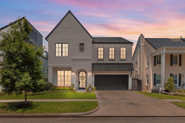 2324 Albans Rd, Houston, TX 77005 - view of front facade featuring driveway, an attached garage, a lawn, a standing seam roof, and a metal roof