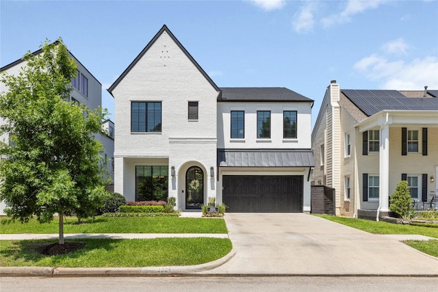2324 Albans Rd, Houston, TX 77005 - view of front of house featuring concrete driveway, a front lawn, a standing seam roof, a garage, and brick siding