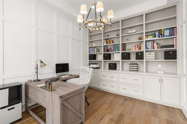 2324 Albans Rd, Houston, TX 77005 - home office featuring a chandelier, a decorative wall, and light wood-type flooring
