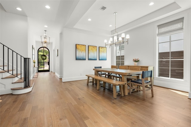 2324 Albans Rd, Houston, TX 77005 - dining space with a chandelier, light wood-style floors, a raised ceiling, and recessed lighting