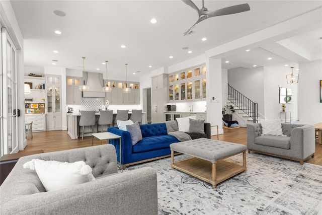 2324 Albans Rd, Houston, TX 77005 - living area featuring bar with sink, stairs, light wood-type flooring, recessed lighting, and ceiling fan