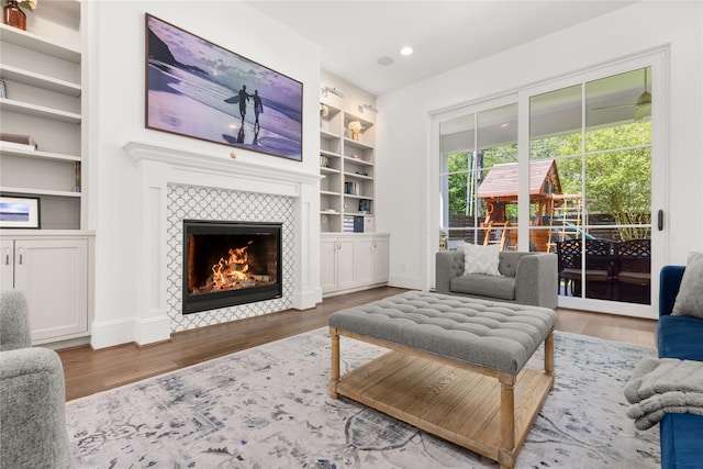 2324 Albans Rd, Houston, TX 77005 - living room featuring built in features, wood finished floors, a tile fireplace, and recessed lighting