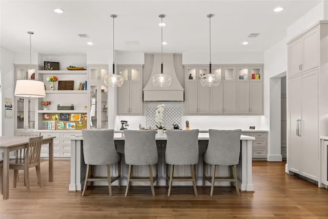 2324 Albans Rd, Houston, TX 77005 - kitchen with custom range hood, light countertops, open shelves, a center island with sink, and hanging light fixtures