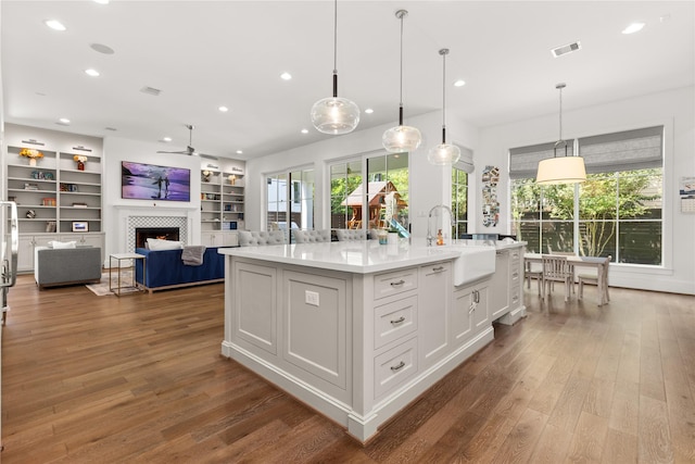 2324 Albans Rd, Houston, TX 77005 - kitchen featuring a ceiling fan, wood finished floors, a tile fireplace, healthy amount of natural light, and recessed lighting