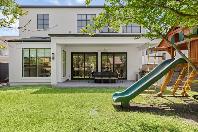 2324 Albans Rd, Houston, TX 77005 - rear view of property with a playground, stucco siding, a lawn, and a patio