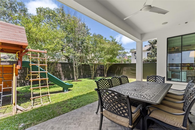 2324 Albans Rd, Houston, TX 77005 - fenced backyard featuring a playground, ceiling fan, outdoor dining area, and a patio