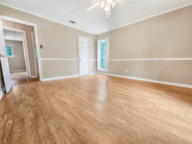 723 Pas Trl, Houston, TX 77336 - spare room with light wood finished floors, a ceiling fan, attic access, and crown molding