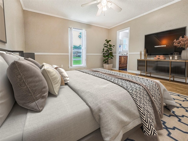 723 Pas Trl, Houston, TX 77336 - bedroom with wood finished floors, crown molding, a textured ceiling, connected bathroom, and a ceiling fan