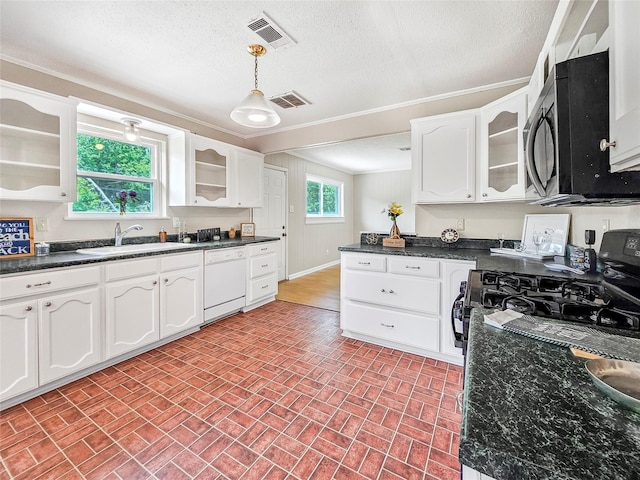 723 Pas Trl, Houston, TX 77336 - kitchen with dishwasher, brick patterned floors, white cabinets, dark countertops, and a textured ceiling