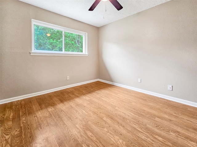 723 Pas Trl, Houston, TX 77336 - empty room with light wood finished floors, ceiling fan, and a textured ceiling
