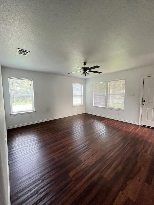 1019 Avenue E Ave E, Rosenberg, TX 77471 - empty room featuring dark wood-style floors, a ceiling fan, and a textured ceiling