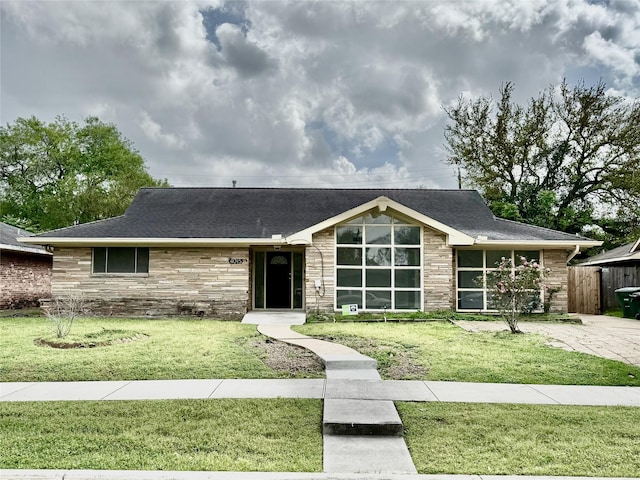 4015 Leeshire Dr, Houston, TX 77025 - view of front of property with stone siding, a front lawn, and a shingled roof